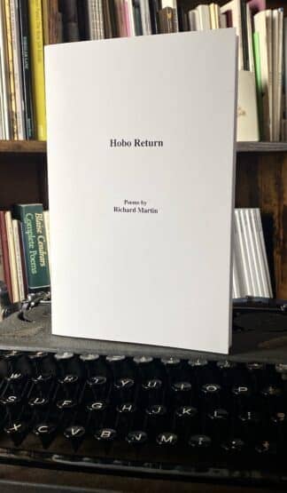 A book titled "Hobo Return" by Richard Martin is propped up on a vintage typewriter, with books on a shelf in the background.
