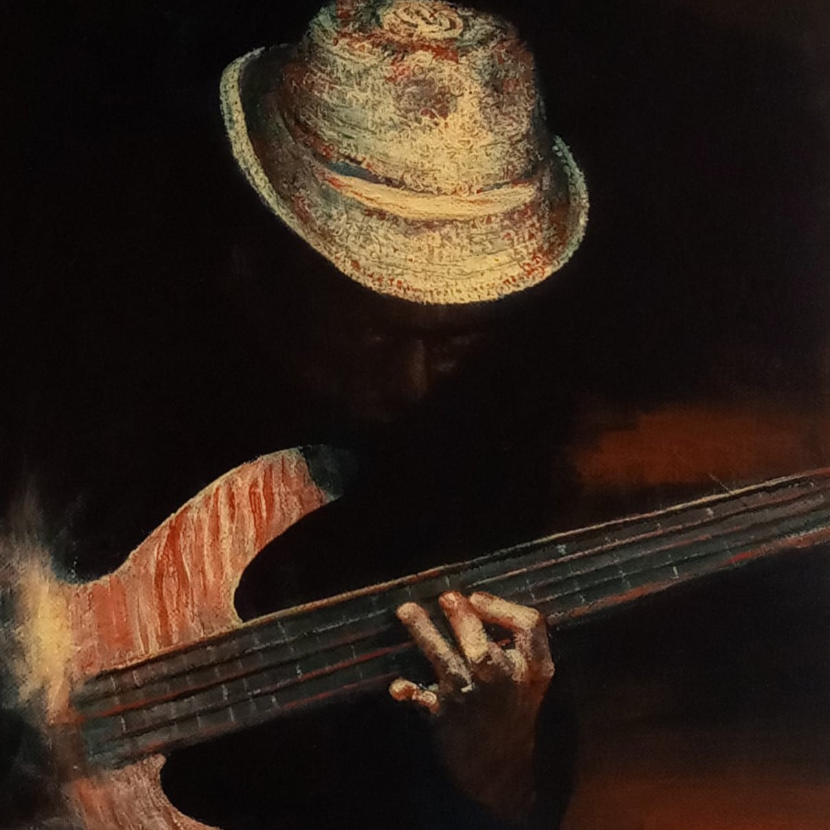A musician wearing a textured hat plays a bass guitar, focusing on the strings. The scene is dimly lit, highlighting the instrument and hands.